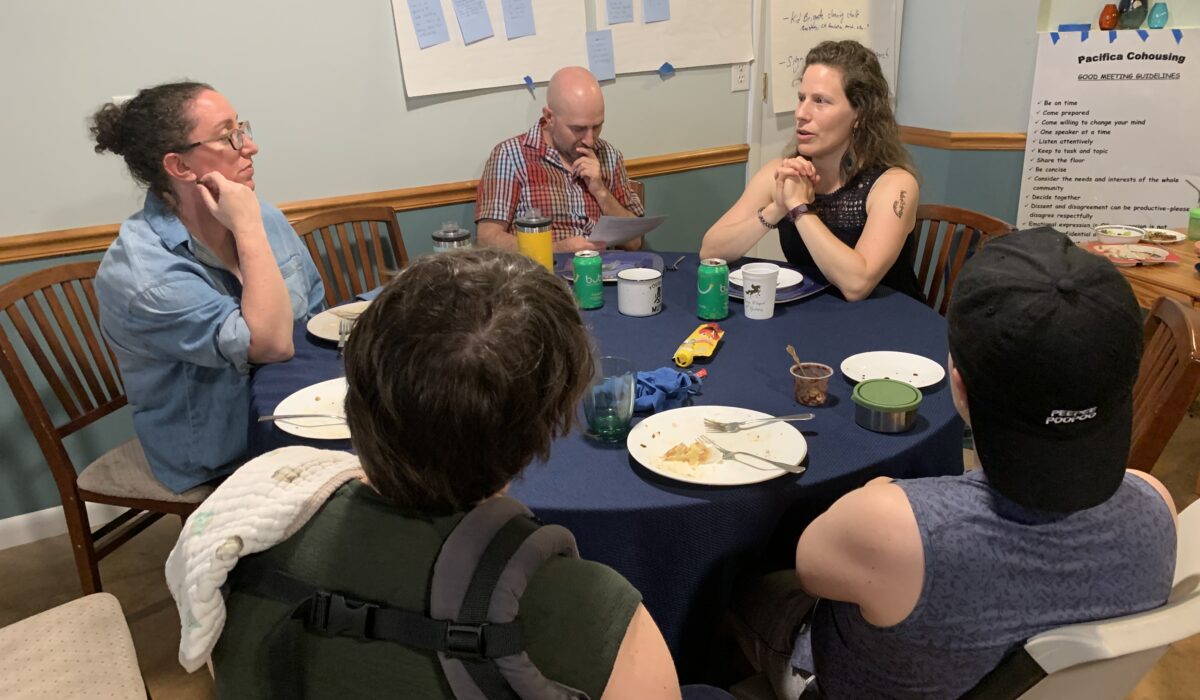 Neighbors sitting around a table talking